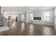 Bright living room seamlessly connects to a kitchen and features a modern fireplace at 111 Hickory Plains Rd, Knightdale, NC 27545