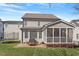 Beautifully landscaped backyard with a patio, outdoor seating, and a screened-in porch at 11342 Oakcroft Dr, Raleigh, NC 27614