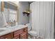 Bathroom featuring white fixtures, wood vanity and framed mirror at 11342 Oakcroft Dr, Raleigh, NC 27614
