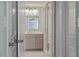 Stylish bathroom with a glass-enclosed shower, modern vanity, and neutral tile flooring at 11342 Oakcroft Dr, Raleigh, NC 27614