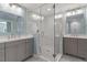 Bright bathroom features dual vanity with grey cabinets, marble countertops, and a glass-enclosed shower at 11342 Oakcroft Dr, Raleigh, NC 27614