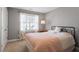 Cozy bedroom with a large window, carpeted floor, and a neutral wall color with white trim at 11342 Oakcroft Dr, Raleigh, NC 27614
