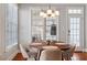 Cozy breakfast nook with ample sunlight, a round table, and modern seating at 11342 Oakcroft Dr, Raleigh, NC 27614
