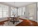 Bright dining area featuring hardwood floors, a modern chandelier, and large windows for natural light at 11342 Oakcroft Dr, Raleigh, NC 27614