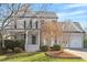 Charming gray two-story home featuring a landscaped front yard and two-car garage at 11342 Oakcroft Dr, Raleigh, NC 27614