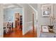 Elegant hallway with hardwood floors, decorative moldings, and views of the dining room and kitchen at 11342 Oakcroft Dr, Raleigh, NC 27614