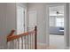 Hallway leading to a cozy living area, showcasing neutral walls and carpet, with stairs and doors at 11342 Oakcroft Dr, Raleigh, NC 27614