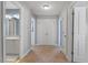 Carpeted hallway with doors and access to bathroom featuring dual sink vanity and neutral wall color at 11342 Oakcroft Dr, Raleigh, NC 27614