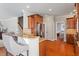 Open kitchen and bar featuring granite counters, modern appliances, and hardwood floors at 11342 Oakcroft Dr, Raleigh, NC 27614