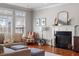 Comfortable living room featuring a fireplace, stylish decor, and hardwood floors for a warm ambiance at 11342 Oakcroft Dr, Raleigh, NC 27614