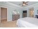 Bright and airy main bedroom featuring neutral decor, ample closet space, and a ceiling fan at 11342 Oakcroft Dr, Raleigh, NC 27614