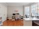 Bright office space with hardwood floors, two desks, a guitar, and natural light from the window at 11342 Oakcroft Dr, Raleigh, NC 27614