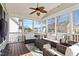 Inviting screened-in porch with comfortable seating, string lights, and a ceiling fan at 11342 Oakcroft Dr, Raleigh, NC 27614