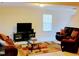 Inviting living room featuring cozy sofas, a modern TV stand, and a stylish glass coffee table at 1141 Early Rise St, Raleigh, NC 27610