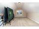 Spacious attic area with neutral carpet and a window for natural light, perfect for recreation at 121 Stone Nut Trl, Fuquay Varina, NC 27526