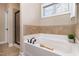 Bright bathroom with soaking tub, tiled backsplash, and glass-enclosed shower at 121 Stone Nut Trl, Fuquay Varina, NC 27526