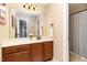 Hall bathroom featuring a shower and tub combo, vanity, large mirror and neutral tones at 121 Stone Nut Trl, Fuquay Varina, NC 27526