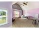 Comfortable room with vaulted ceiling, neutral carpet, a chair, desk, and ceiling fan at 121 Stone Nut Trl, Fuquay Varina, NC 27526