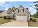 Lovely two-story home with a well-kept lawn and a convenient two-car garage at 121 Stone Nut Trl, Fuquay Varina, NC 27526