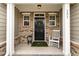 Inviting front porch featuring a cozy rocking chair and tasteful decor at 121 Stone Nut Trl, Fuquay Varina, NC 27526