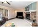 Spacious living room boasts a stone fireplace and archway to entry way at 121 Stone Nut Trl, Fuquay Varina, NC 27526