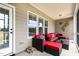 Comfortable porch with seating and firewood on a covered patio at 121 Stone Nut Trl, Fuquay Varina, NC 27526