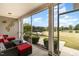 Inviting screened porch with comfortable seating and picturesque views of the backyard and lake at 121 Stone Nut Trl, Fuquay Varina, NC 27526
