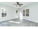 Bright and airy bedroom with large windows, hardwood floors, a ceiling fan, and a view of the outdoors at 123 Pretty Run Branch Ln, Wendell, NC 27591
