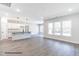 Spacious living area showcasing a modern kitchen with an island, hardwood floors, and large windows at 123 Pretty Run Branch Ln, Wendell, NC 27591