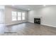 Cozy living room featuring hardwood floors, a fireplace, and large windows offering plenty of natural light at 123 Pretty Run Branch Ln, Wendell, NC 27591