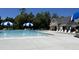 A clear view of the large in-ground swimming pool and nearby pool house, surrounded by lush greenery at 123 Pretty Run Branch Ln, Wendell, NC 27591