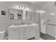 Elegant bathroom with dual vanities, modern fixtures, and a glass-enclosed shower at 1700 Tiffany Bay Ct # 303, Raleigh, NC 27609