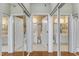 Hallway of full bathrooms with white vanities, and marble tiled floors at 1700 Tiffany Bay Ct # 303, Raleigh, NC 27609