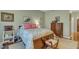 Bedroom features a floral bed, a chest of drawers and side table at 1700 Tiffany Bay Ct # 303, Raleigh, NC 27609