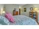 Cozy bedroom with floral patterned bed, pink pillows and vintage furnishings at 1700 Tiffany Bay Ct # 303, Raleigh, NC 27609