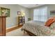 Bright bedroom with floral bedding, decorative wall art, and stylish furnishings at 1700 Tiffany Bay Ct # 303, Raleigh, NC 27609
