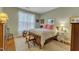 Bedroom featuring a bed with floral bedding and an upholstered chair at 1700 Tiffany Bay Ct # 303, Raleigh, NC 27609