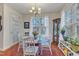 Charming dining room featuring a glass table, white chairs, and natural light from the large windows at 1700 Tiffany Bay Ct # 303, Raleigh, NC 27609