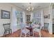 Bright dining area with a glass table, decorative chairs, and natural light streaming through large windows at 1700 Tiffany Bay Ct # 303, Raleigh, NC 27609