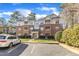 Exterior view of multi-story brick and siding condo complex with car in parking lot at 1700 Tiffany Bay Ct # 303, Raleigh, NC 27609