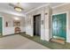 Hallway of a condo building featuring neutral tones, a green door, and an elevator at 1700 Tiffany Bay Ct # 303, Raleigh, NC 27609