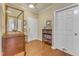 Hallway with a decorative display case, neutral walls, white trim, and a light wood floor at 1700 Tiffany Bay Ct # 303, Raleigh, NC 27609