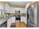 Well-equipped kitchen featuring stainless steel appliances, white cabinets, and ample counter space at 1700 Tiffany Bay Ct # 303, Raleigh, NC 27609