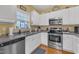 Functional kitchen with stainless steel appliances, white cabinetry, and plenty of counter space at 1700 Tiffany Bay Ct # 303, Raleigh, NC 27609