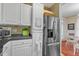 Spacious kitchen featuring stainless steel refrigerator, white cabinets, and access to the dining area at 1700 Tiffany Bay Ct # 303, Raleigh, NC 27609