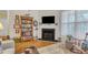 Bright living room featuring a fireplace, hardwood floors, and a cozy seating area with natural light at 1700 Tiffany Bay Ct # 303, Raleigh, NC 27609