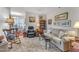 Inviting living room featuring a comfortable couch, rocking chair, and a view into the dining area at 1700 Tiffany Bay Ct # 303, Raleigh, NC 27609