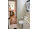 Functional half bath with a view into an adjacent sitting area at 1704 Delaware Ave, Durham, NC 27705