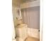 Cozy bathroom with a striped shower curtain, vanity storage, and neutral tones at 1704 Delaware Ave, Durham, NC 27705
