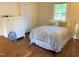 Cozy bedroom featuring hardwood floors, closet, natural light and a neutral color scheme, creating a serene and inviting space at 1704 Delaware Ave, Durham, NC 27705